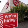 A red-and-white "We're Hiring" sign outside a Target store.