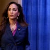 Assistant AG for Civil Rights Harmeet Dhillon in a blue jacket walks onto a stage.