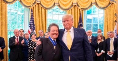 Donald Trump and Arthur Laffer smiling