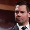 Eric Swalwell listens during a news conference at the U.S. Capitol Building.