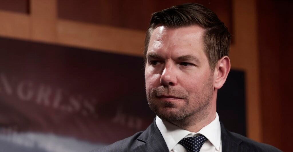 Eric Swalwell listens during a news conference at the U.S. Capitol Building.