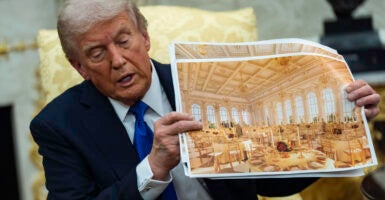 President Donald Trump shows off renderings of the new White House ballroom.