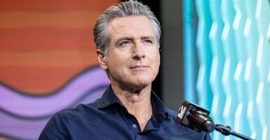 Gavin Newsom in front of a microphone