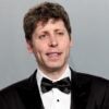 Sam Altman smiling while wearing a tuxedo.