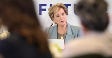 Linda McMahon speaking while seated.