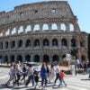 People walking past the Colosseum