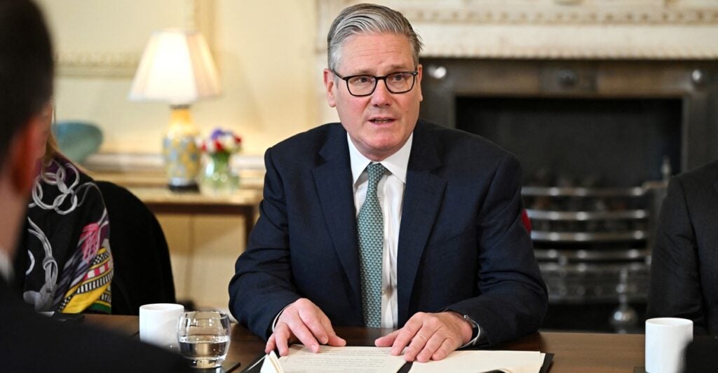 Keir Starmer seated at a table