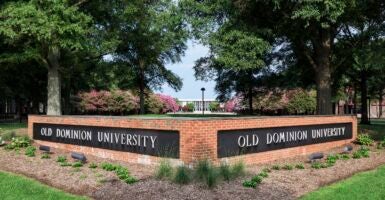 A low brick wall with two sides reading 