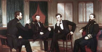A panting of Abraham Lincoln and three other men, all seated.