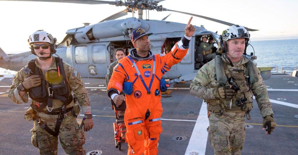 NASA astronaut Victor Glover, Artemis II pilot is assisted off the flight deck after arriving aboard USS John P. Murtha Friday, April 10, 2026.