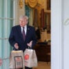 President Donald Trump receives a DoorDash delivery of McDonald's outside the Oval Office of the White House on April 13, 2026.