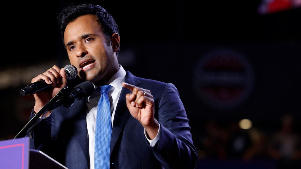 Vivek Ramaswamy gestures while up at a podium.