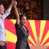 Kari Lake and Blake Masters in front of an Arizona flag