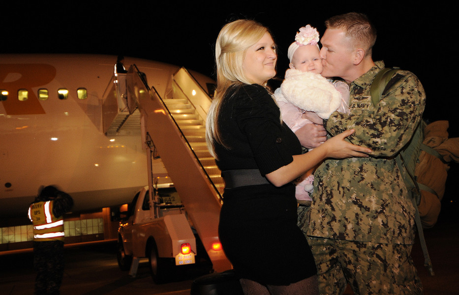 Naval Air Crewmen 2nd Class Ryan Roberson greets his wife and for the first time, his 5-month-old daughter, during the homecoming in 2012. He returned home to Naval Air Station Whidbey Island from a six-month deployment to the U.S. 5th Fleet area of responsibility. (Photo: U.S. Navy photo by Mass Communication Specialist 2nd Class Emmanuel Rios/Released)